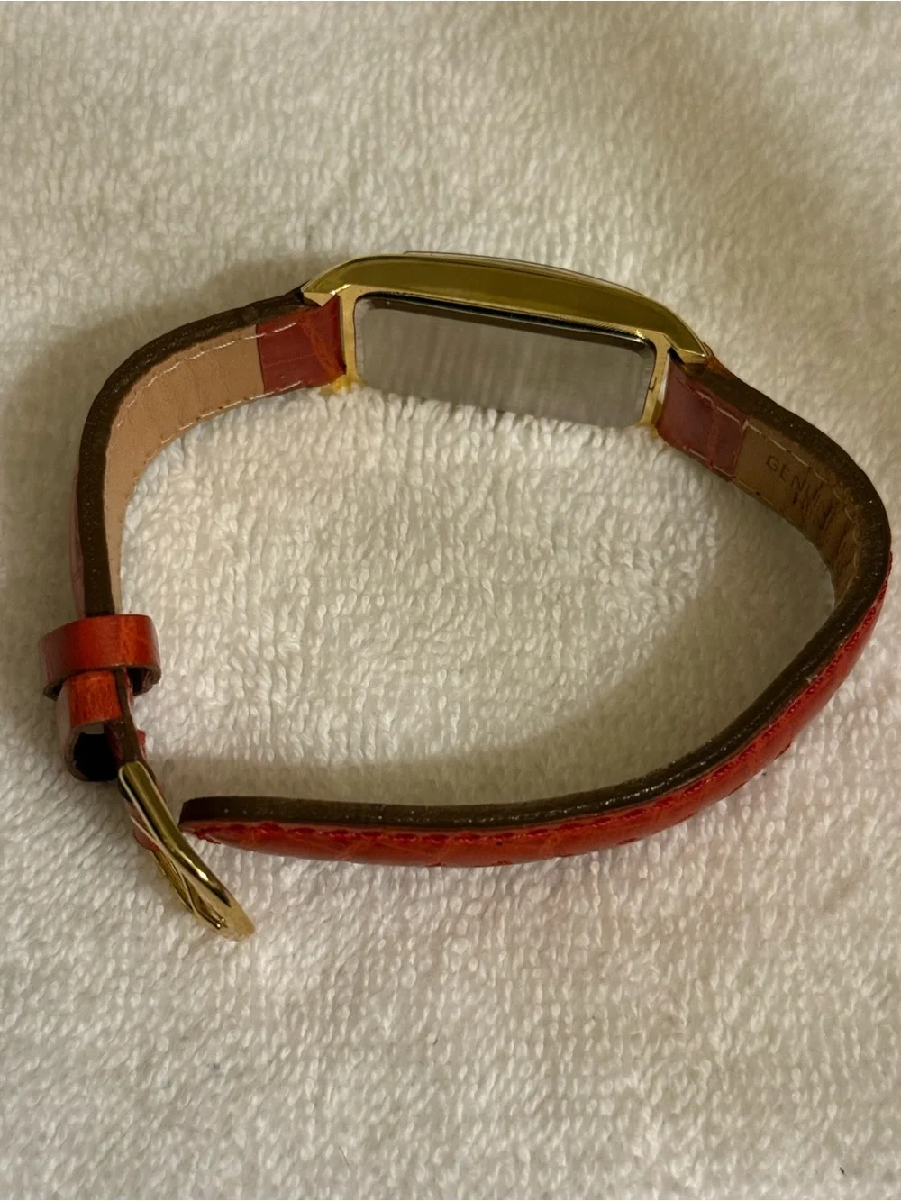 Clarins Gold-Tone Rectangular Watch with Red Strap and White Dial